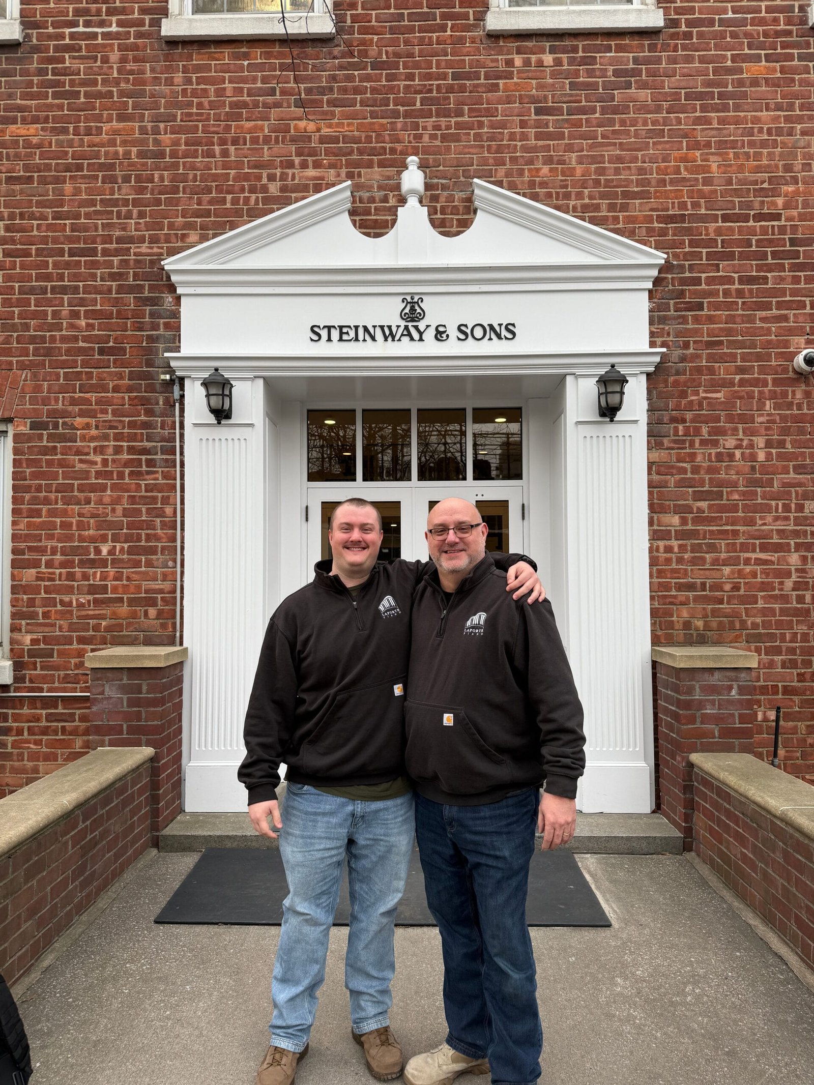 Andrew and Al LaPorte Standing in front of the Steinway and Sons Piano Factory