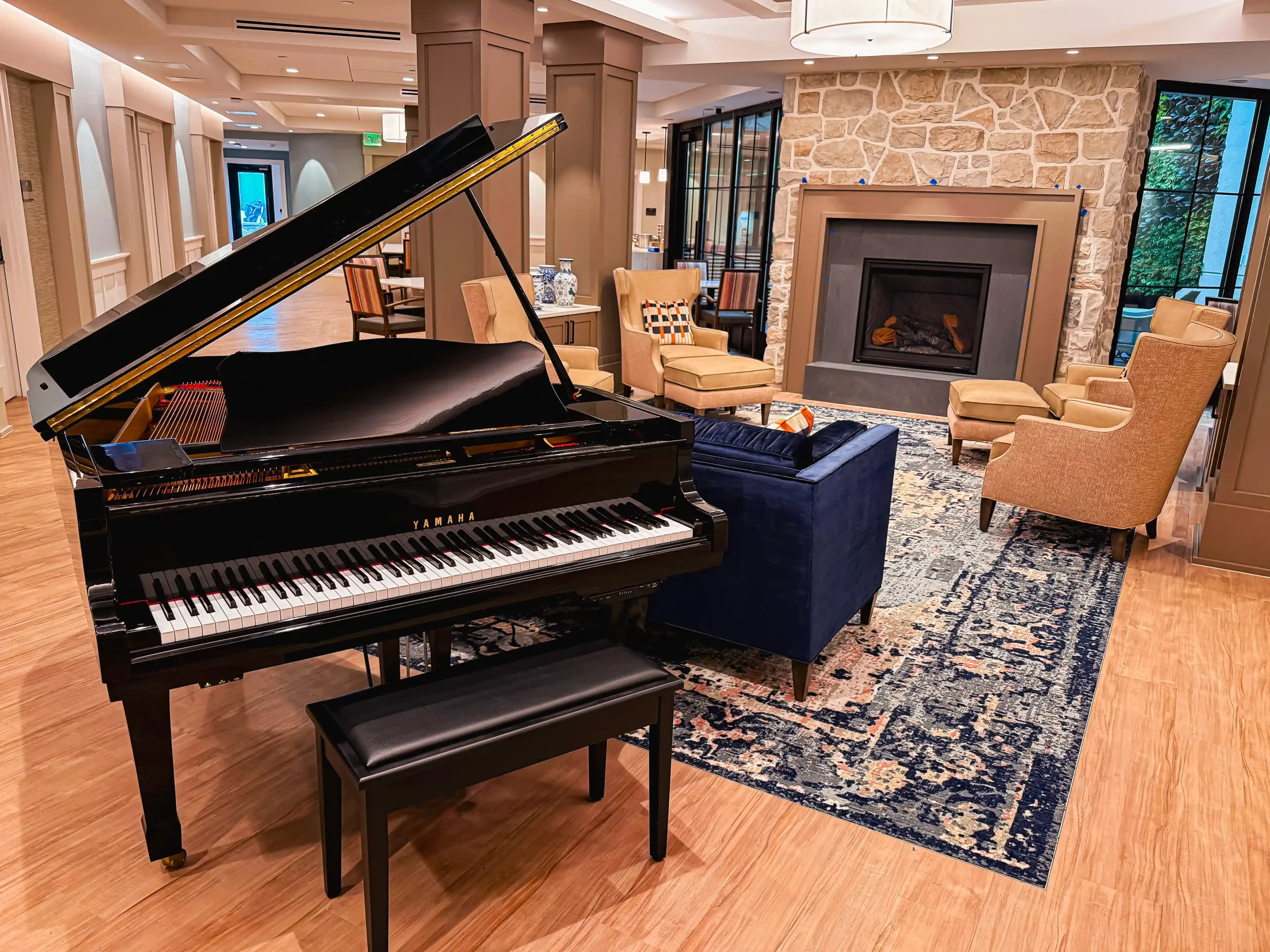Yamaha Grand Piano Located in Front of Living Room Fireplace